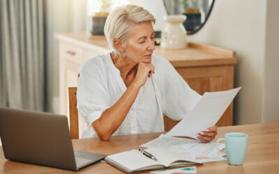 Senior woman, debt and laptop bills payment for loan budget and retirement finance paperwork at home. Retired Ukraine elderly person reading pension, loan and mortgage savings financial bank report