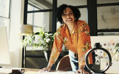 Creative black designer stands while smiling. Stock photo