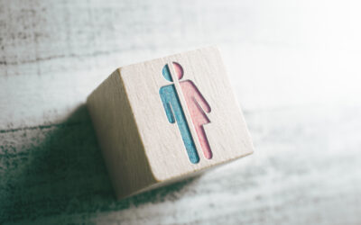 Gender Signs For Male And Female Cut In Half On A Wooden Block On A Table