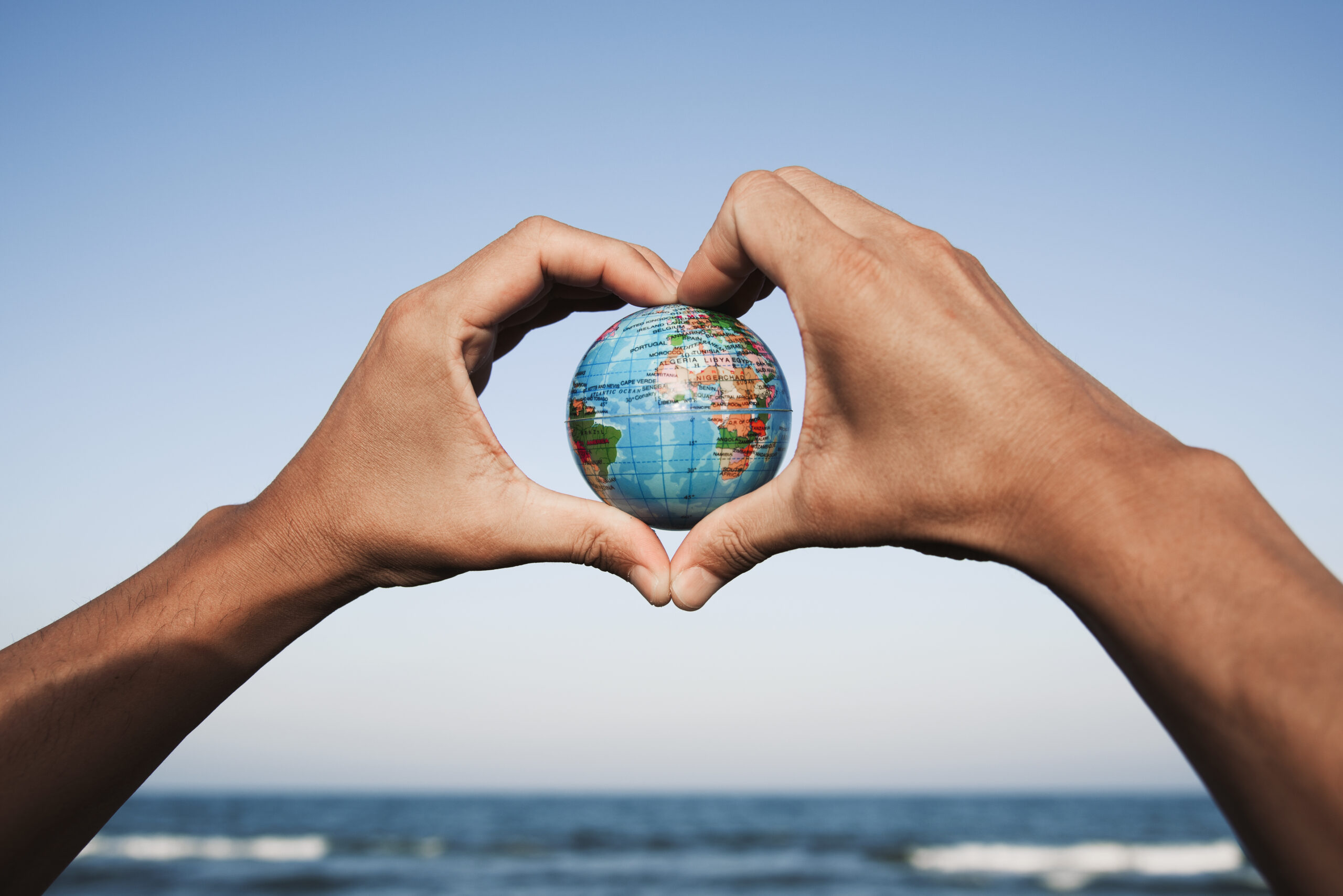 young man with a world globe in his hands