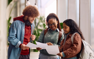 2026 Exam Results Multiracial group of university students examining their test results.